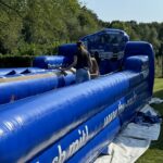 Besonders beliebt bei Erwachsenen und Kindern war das „Horizontal-Bungee“, bei dem die Teilnehmenden versuchen mussten, gegen die Zugkraft eines Gummiseils eine möglichst weite Strecke zu laufen. (Foto: THW/Sandro Wiggerich)